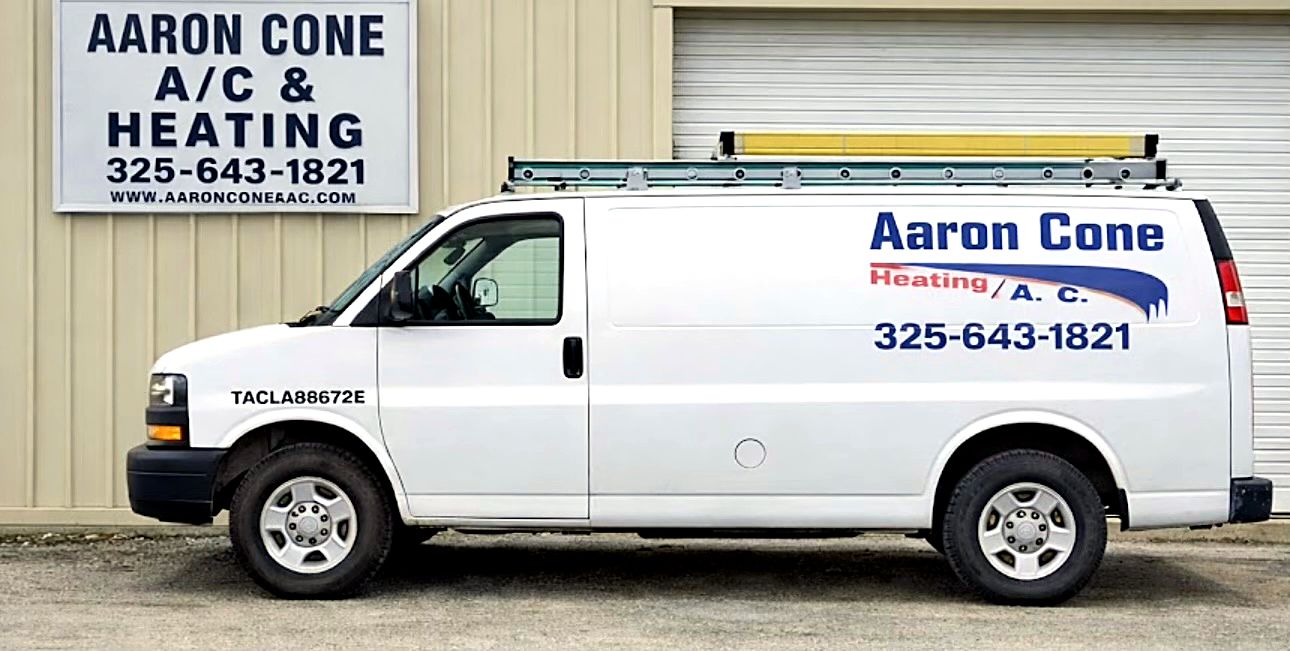 Aaron Cone service van, lettered with the shop phone number, parked in front of the shop sign on Coggin Ave